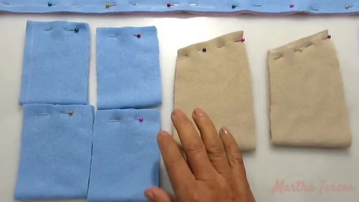 Coser los puños y mangas: Se doblan las mangas y se cose la parte donde están los alfileres.