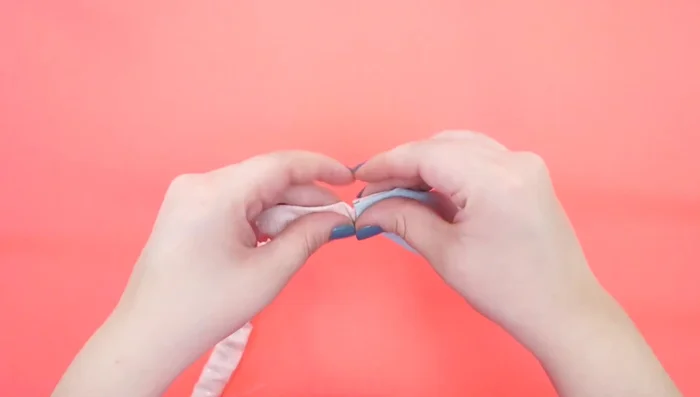 Une el collar al pañuelo. Introduce los extremos del collar en los rollitos del pañuelo y cose para asegurar.