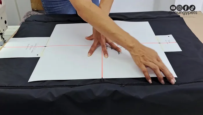 Sostener el centro para evitar movimientos durante la colocación de la tela y los pompones.