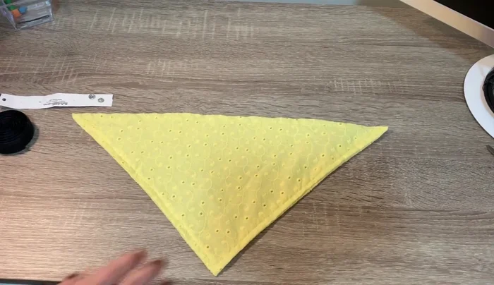 Cerrar la pañoleta con el método deseado (broches de presión, velcro o botón). Asegurarse de que el cuello no quede demasiado apretado.