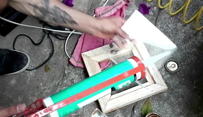 Pegado del vidrio a la ventanita con silicón.