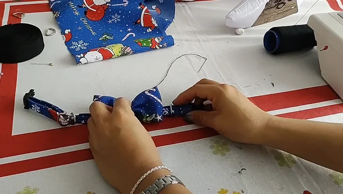 Unir el corbatín a la riata cerca de la medialuna de la correa con costura.