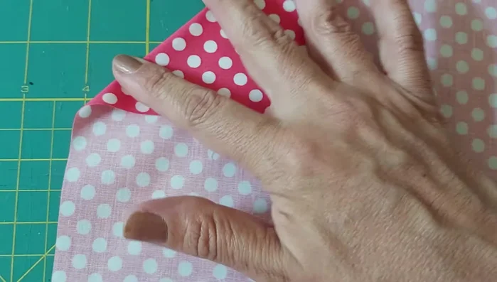 Doblar y coser: Doblar la tela a lo largo de las líneas marcadas. Coser un pespunte a lo largo de cada línea doblada.