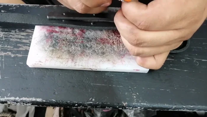 Perforaciones e incisiones para unir los extremos de la empuñadura.