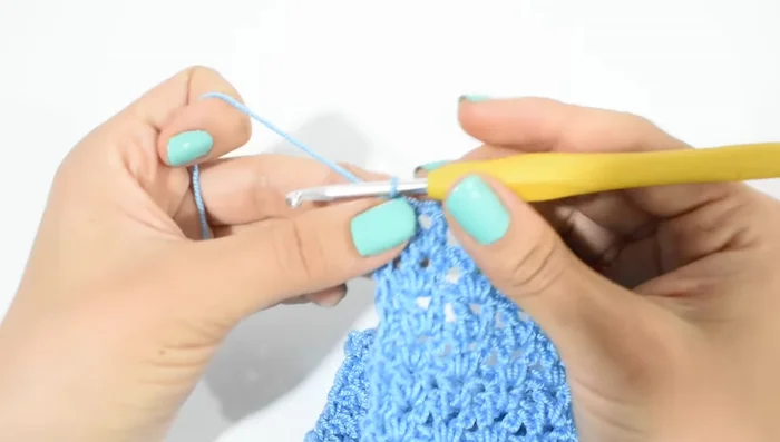 Disminuciones: Para dar forma a la cola, disminuir un punto por vuelta. Subir con 2 cadenas, tejer como antes, pero en la última V, hacer solo un punto alto. Repetir en vueltas pares hasta obtener la forma deseada. (8 vueltas en este ejemplo)