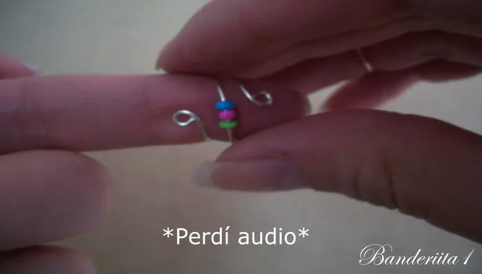 Crea pequeños círculos en ambos extremos del alambre con las cuentas, utilizando las pinzas.